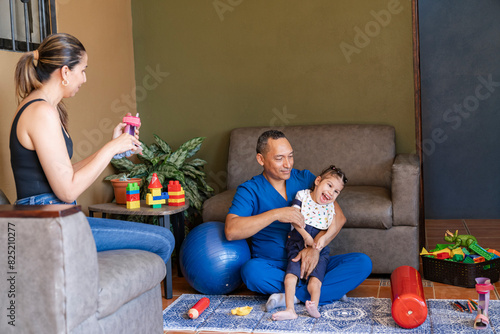Man physiatrist with girl and observing mother