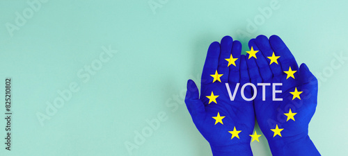 EU election, hand with european union flag, blue and yellow stars, citizens of Europe voting Parliament