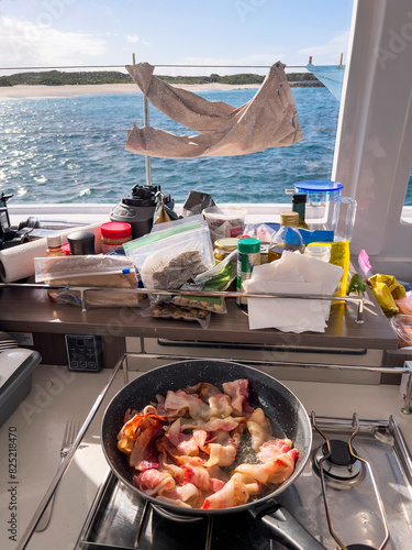 Morning on boat and bacon cooking breakfast and laundry drying  photo