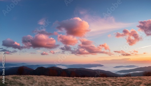 Stunning romantic and relaxing sunrise with some pink illuminated clouds moving across a blue sky. Long exposure, natural background. © Willard