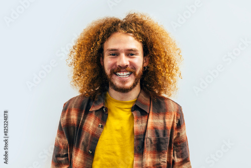 Cheerful Young Man with Curly Hair Smiling photo