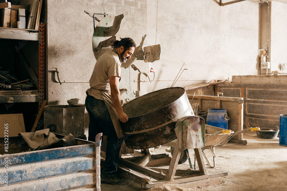 Diabetic Man Preparing Sand Mix in Cement Tile Factory During the Day. Diabetic Man Preparing Sand Mix in Cement Tile Factory During the Day.