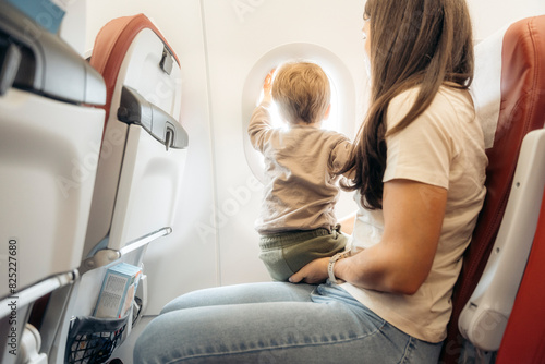 Mother and child traveling by plane photo