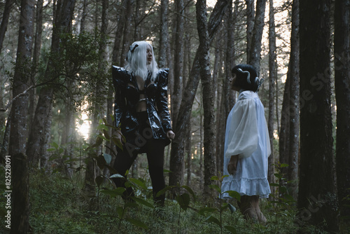 Women with costumes walking through the forest photo