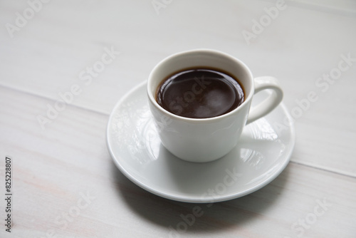 Little white Cup of black expresso coffee