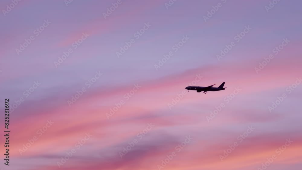 Airplane flying in the sky at pink and orange sunrise or sunset. The view of large airplane in the sunset sky. Traveling and transportation concept. Airplane flying in the sky at pink and orange sunrise or sunset. The view of large airplane in the sunset sky. Traveling and transportation concept.