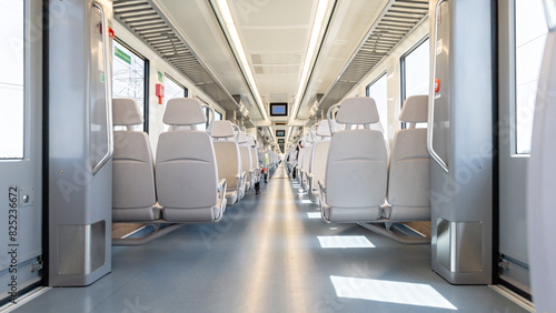 The interior of a nearly empty electric train car photo