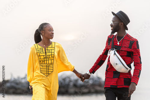 Senegalese Couple Holding Hands on Beach Stroll photo