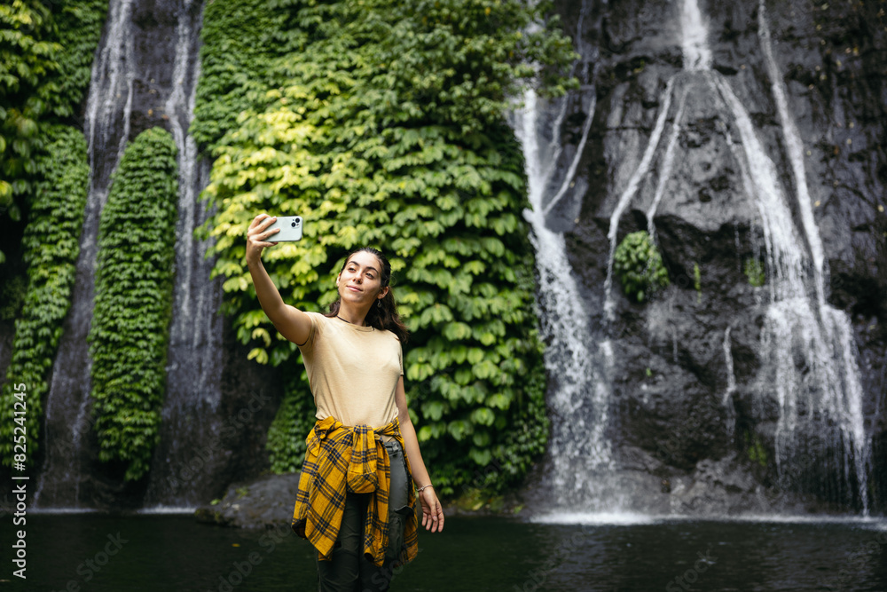 Hiker taking selfies at a waterfall Hiker taking selfies at a waterfall