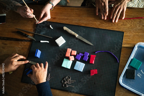 Three pairs of hands crafting photo