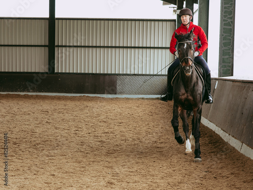 Rider training horse in equestrian club arena, copy space