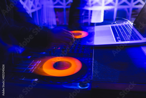 Vibrant DJ session with colorful lighting at nightclub