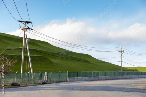 Landfill refuse landscape covered in grass nobody and power line photo