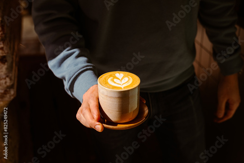 Barista holding a coffee in a specialty coffee shop
