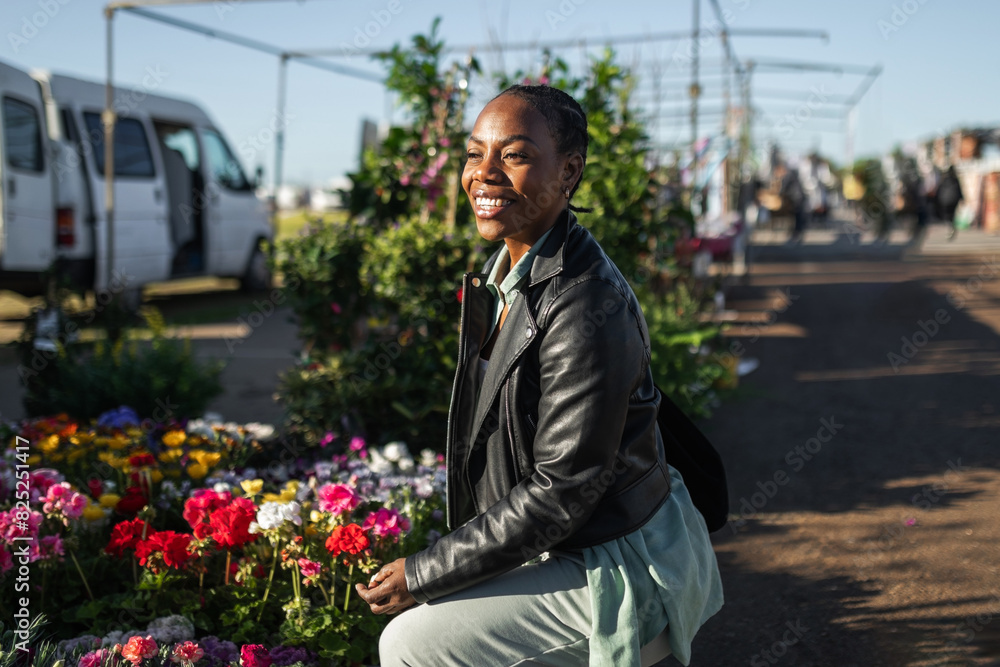 black woman buying flowers at a market