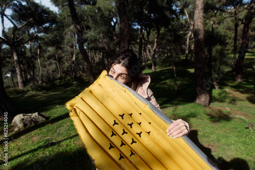 young woman inflating an air mattress photo