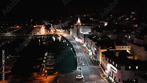 Seafront and Victoria Marina St Peter Port Guernsey at night. Drone flight with illuminated sea front. photo