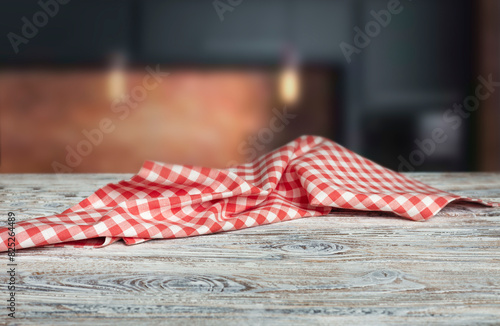 Dark kitchen wooden empty table decorated with red picnic cloth, layout, food advertisement display.