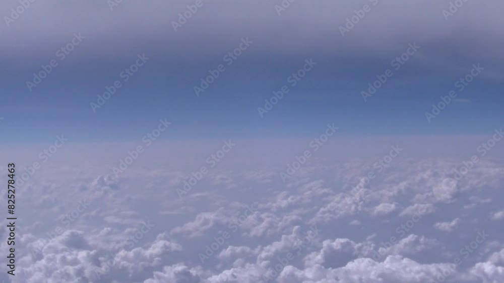 White Cumulus clouds over land and blue horizon of sky - view from above, from airplane flight. Topics: weather, meteorology, aerial, travel, air transport, atmosphere, space White Cumulus clouds over land and blue horizon of sky - view from above, from airplane flight. Topics: weather, meteorology, aerial, travel, air transport, atmosphere, space