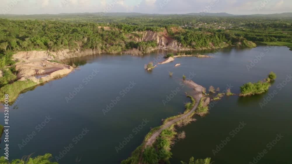 Drone flying over a lake and dirt road Drone flying over a lake and dirt road