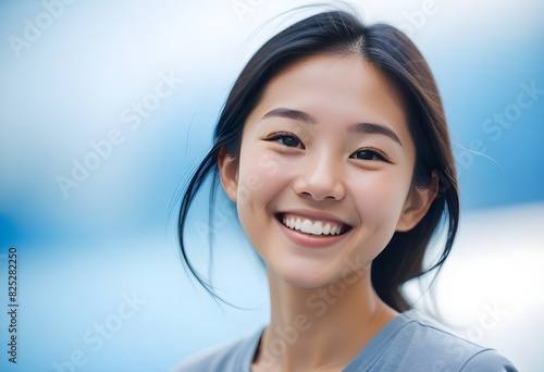 Portrait of a Cheerful Asian Japanese, Korean young woman, girl. close-up. smiling. sky, outdoor, vibrant. 