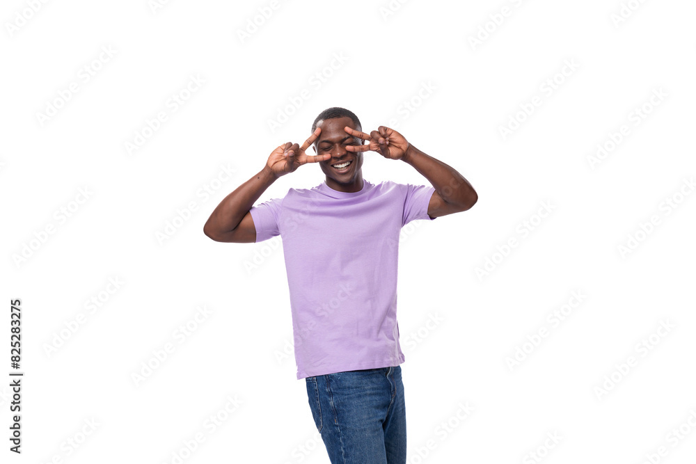 Fototapeta premium young authentic slender american guy dressed in light lilac t-shirt and jeans