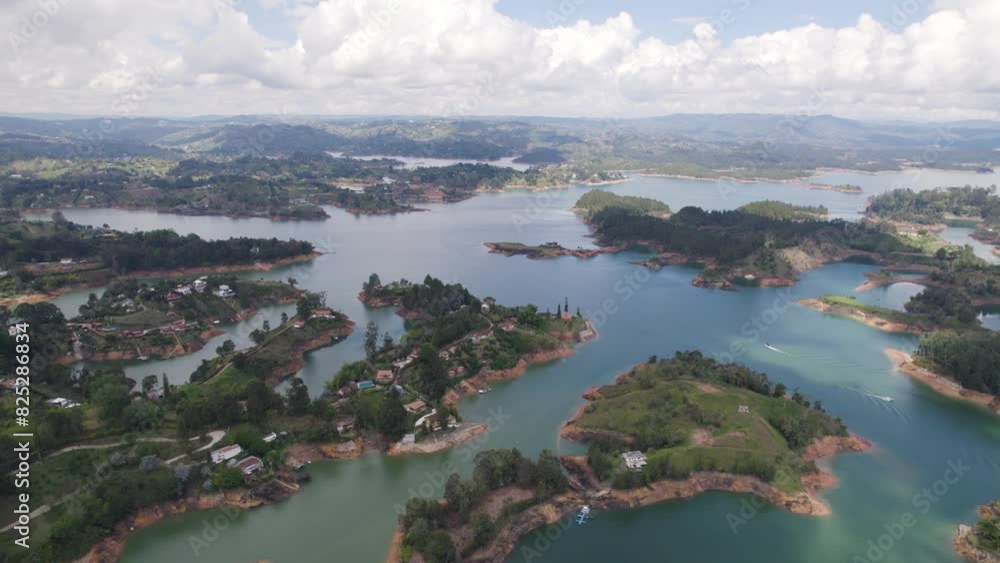 El peñón de guatapé lake with lush green islands and surrounding mountains, aerial view El peñón de guatapé lake with lush green islands and surrounding mountains, aerial view