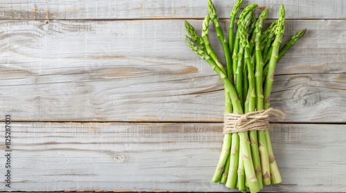 Bunch of Fresh Green Asparagus Spears Arranged on a Rustic Wooden Table Surface with Ample Copy Space Above for Recipes,Menus,or Text Overlays Healthy,Organic,and Natural Food Concept description:A