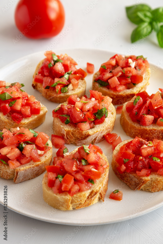 Homemade Bruschetta with Basil and Tomatoes on a Plate, side view. Homemade Bruschetta with Basil and Tomatoes on a Plate, side view.