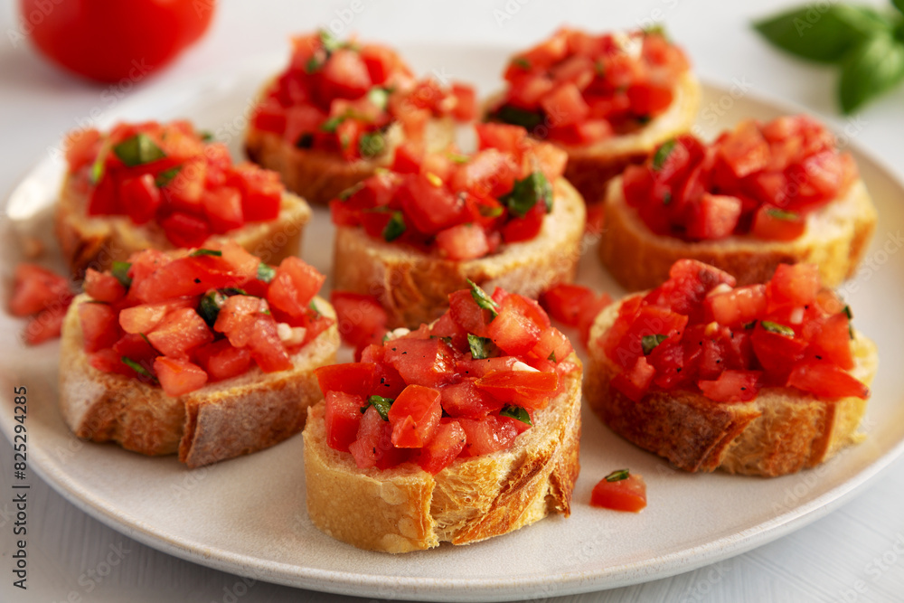 Homemade Bruschetta with Basil and Tomatoes on a Plate, side view. Homemade Bruschetta with Basil and Tomatoes on a Plate, side view.