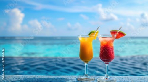 Two tropical cocktails by a swimming pool.