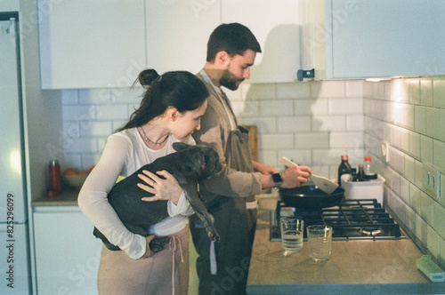 Man cooking dinner near pregnant wife photo