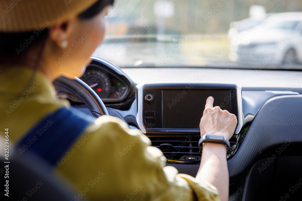 Woman using touch screen GPS in car Woman using touch screen GPS in car