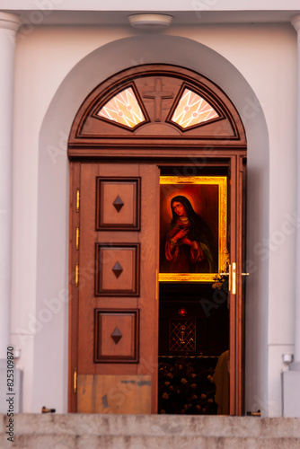 View of the open door to the church, a visible religious picture.