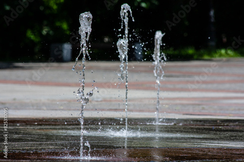 A stream of water from the fountain, abstract shapes of water drops.