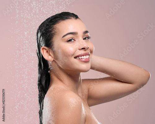 Portrait, cleaning and woman with water splash, wet and dermatology on studio background. Face, person and model with liquid, washing and shower with hygiene, wellness and smile with grooming routine