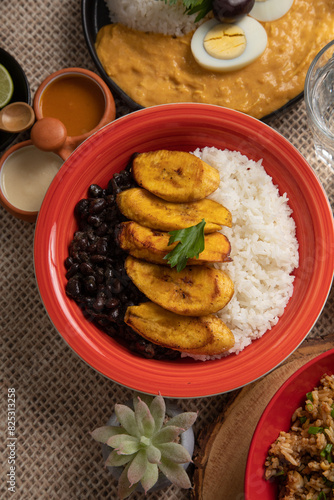 Black beans stew stu with fried plantains banana Buffet table full of lunch assorted dishes Peru Peruvian food