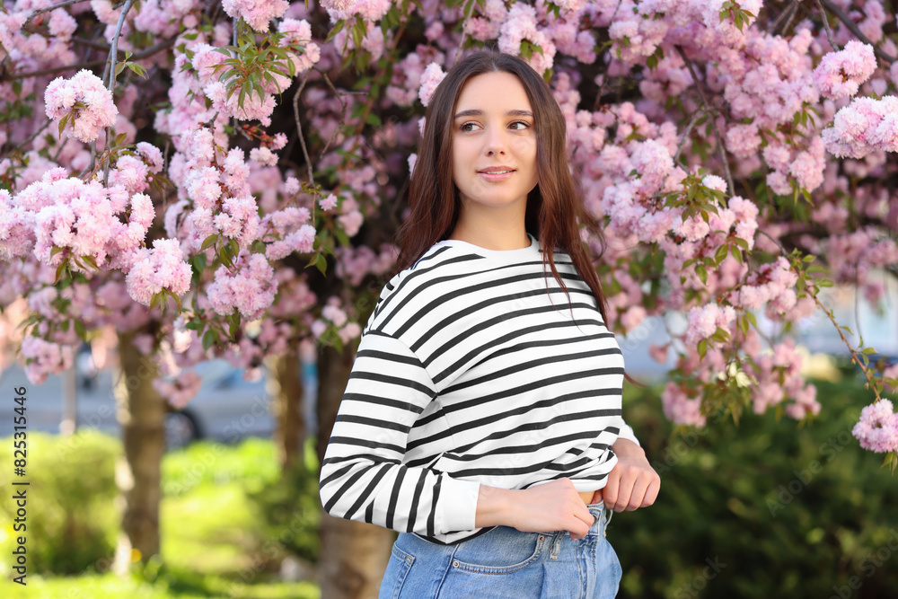 Beautiful woman near blossoming tree on spring day Beautiful woman near blossoming tree on spring day