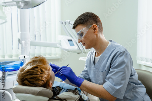 A dentist treats a child's teeth photo