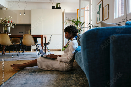 Woman working on laptop at home photo