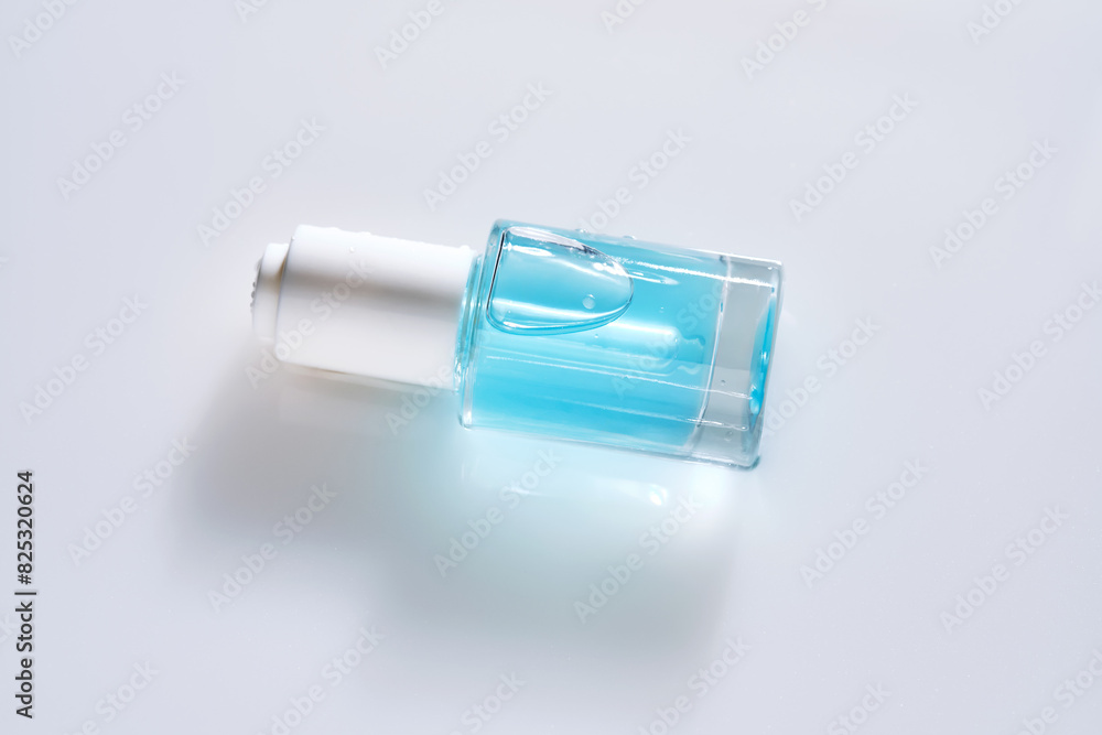 Bottles of serum with a dropper in liquid with pearl tints. Bottles of serum with a dropper in liquid with pearl tints.