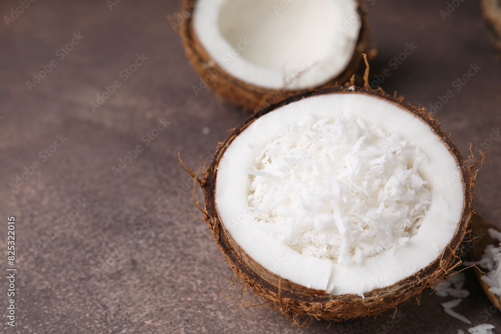 Coconut pieces in nut shell on brown table, space for text Coconut pieces in nut shell on brown table, space for text