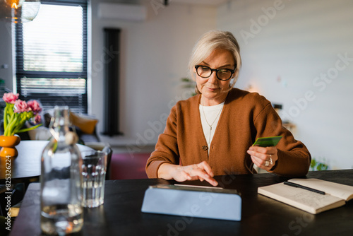 A woman shops online on a tablet