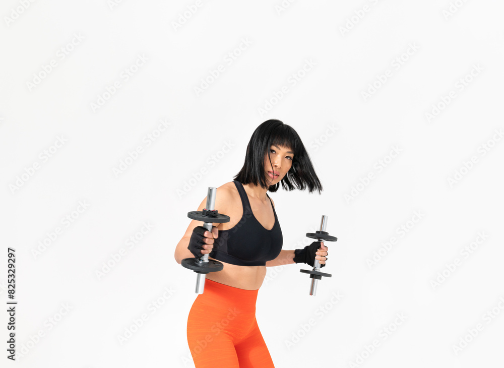 Sporty Asian Woman Exercising With Dumbbells In Studio Sporty Asian Woman Exercising With Dumbbells In Studio