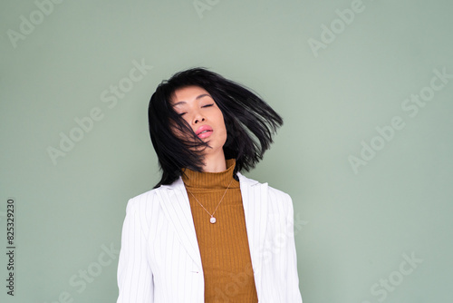 Asian Woman Portrait With Closed Eyes In Motion photo