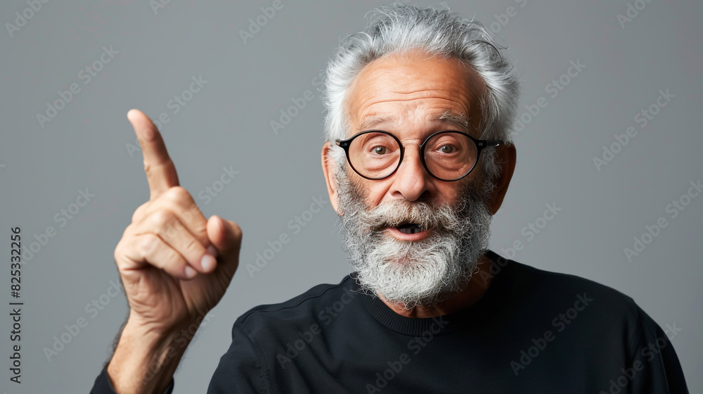 Elderly gentleman with gray hair, beard, glasses, pointing upwards joyfully. Elderly gentleman with gray hair, beard, glasses, pointing upwards joyfully.