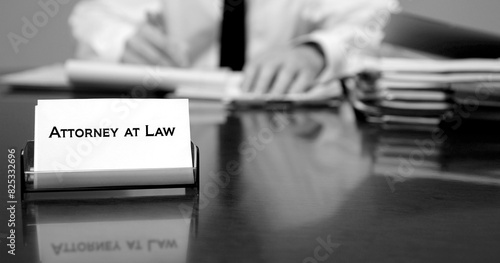 Attorney at Desk with Business Card Writing on Legal Pad