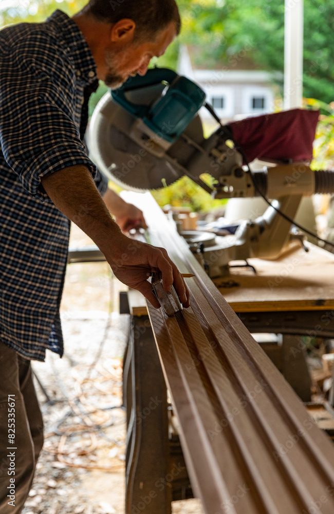 Construction Carpenter handyman cutting wood with saw Construction Carpenter handyman cutting wood with saw