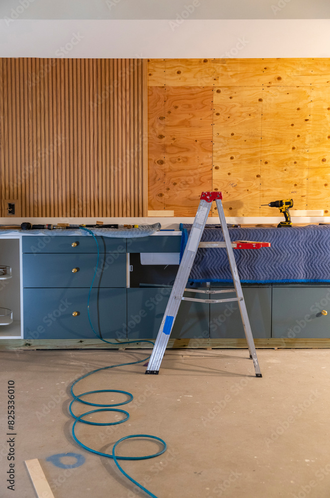 © Raymond Forbes LLC/Stocksy - Home improvement project kitchen construction with drill