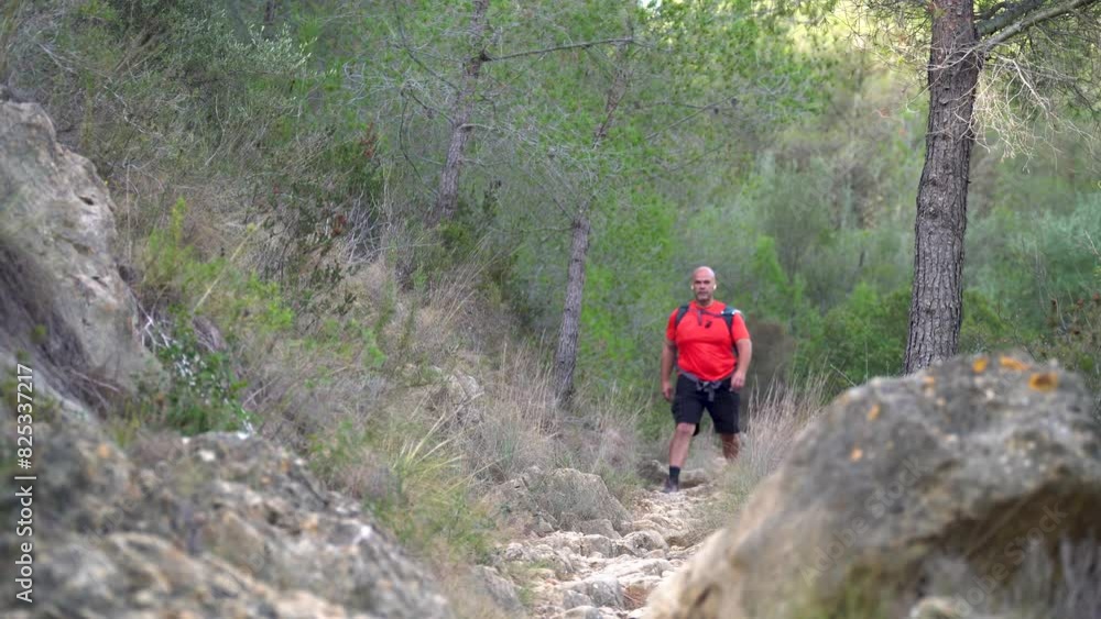 One person hiking on a rocky path, on a summer day, real time video. One person hiking on a rocky path, on a summer day, real time video.